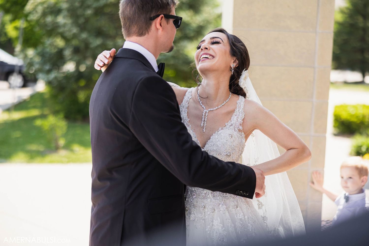 Newlyweds share a joyful moment together outdoors during their wedding celebration.