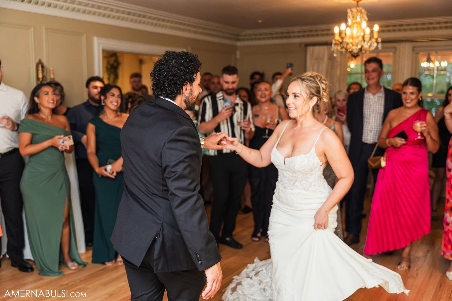 Couples dancing during wedding reception in elegant ballroom.