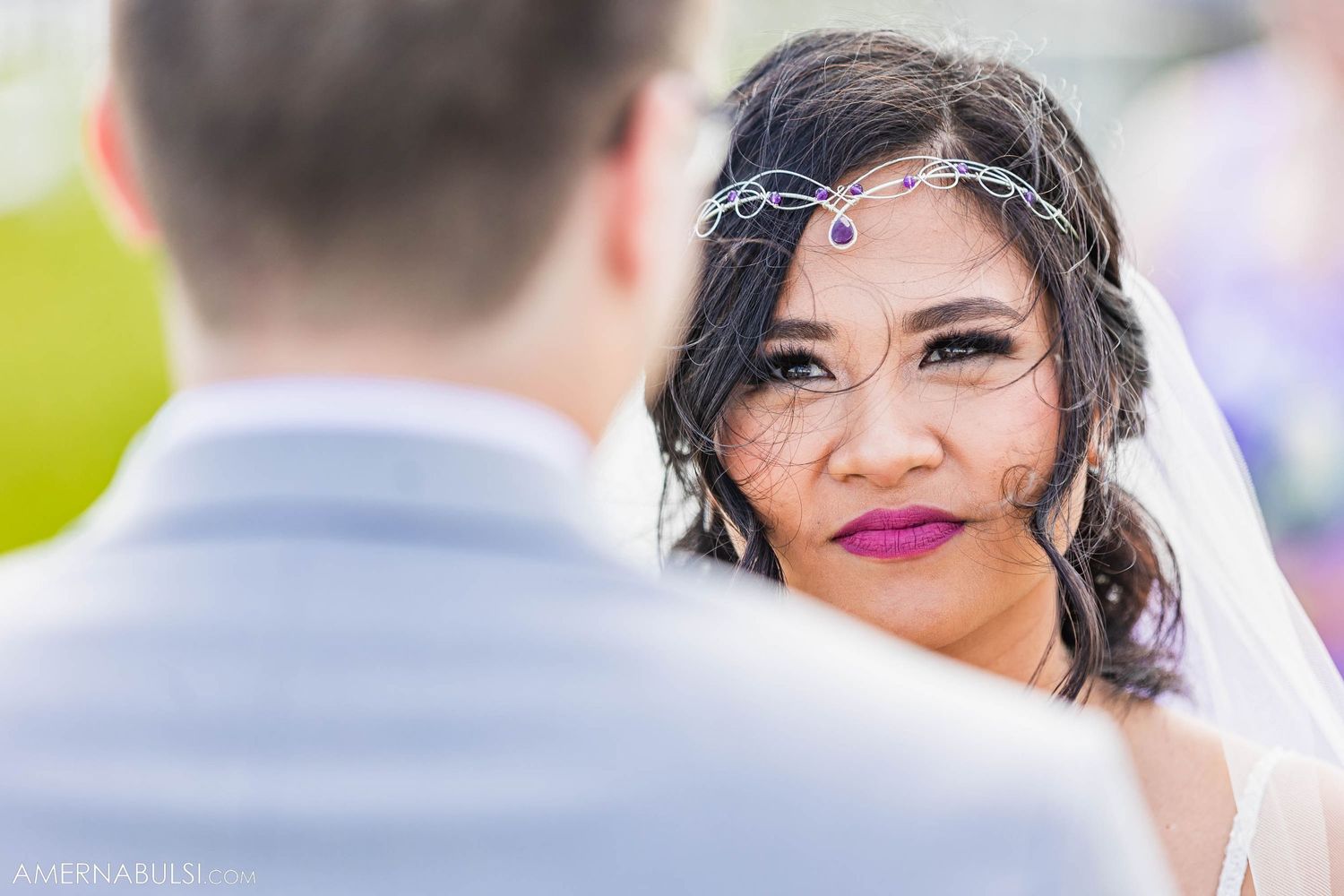 Intimate moment during outdoor wedding ceremony with marina backdrop.