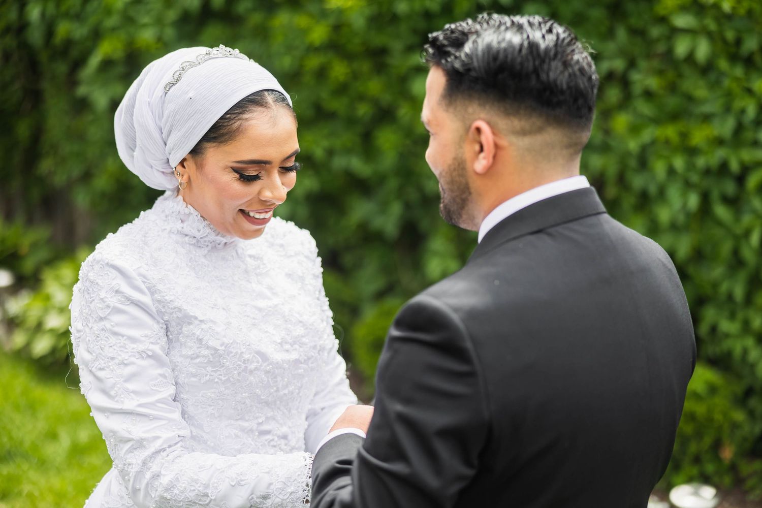 Intimate moment between newlyweds during outdoor wedding ceremony.