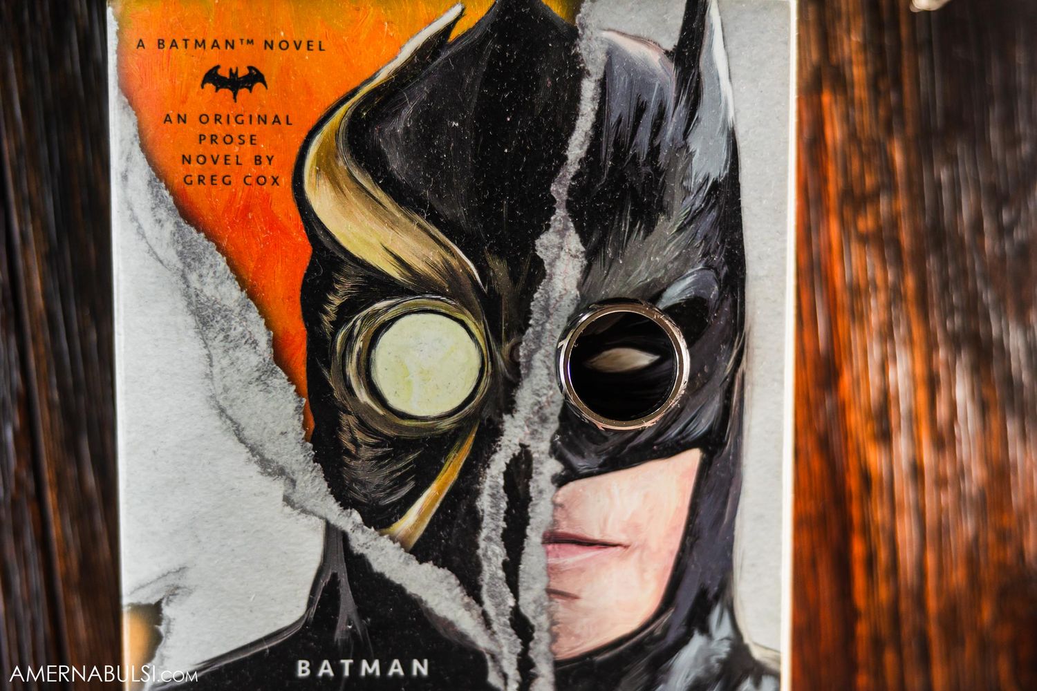 Batman comic book cover showing split face design in orange and black.
