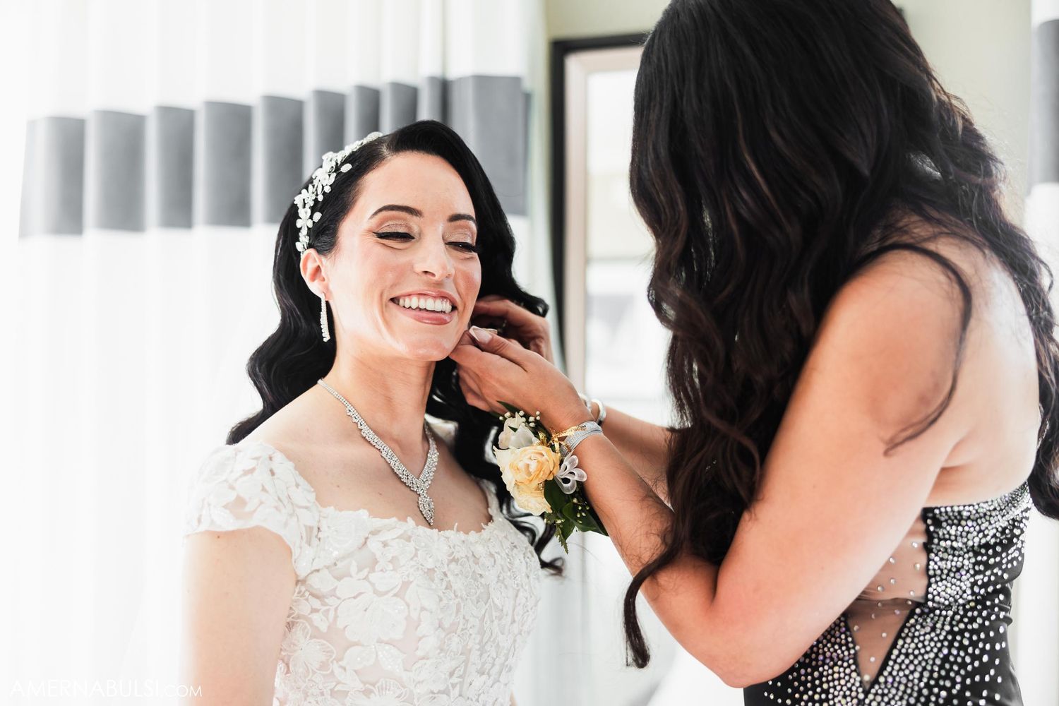 Wedding preparation moment with elegant lace dress and sparkly accessories.