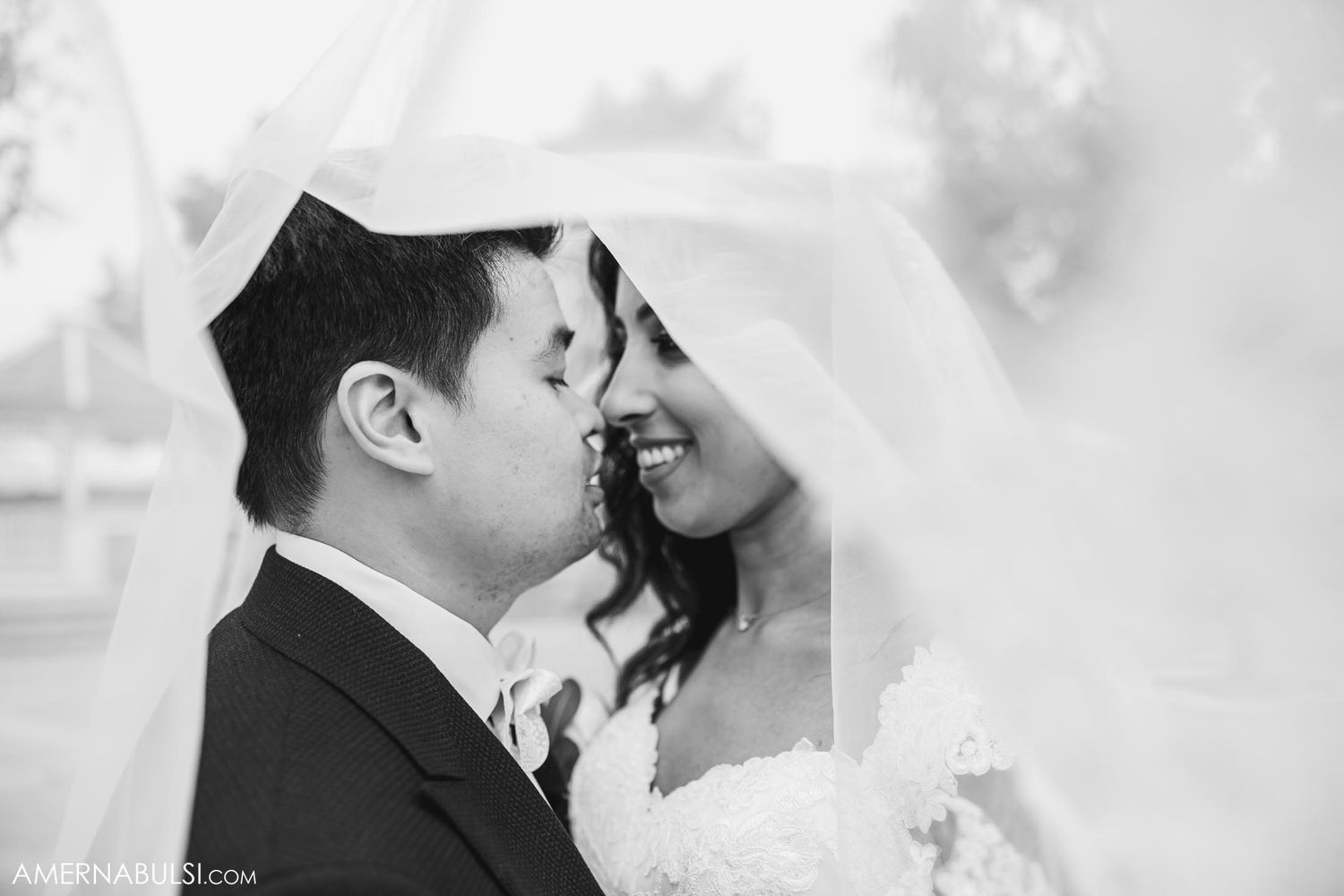 Intimate black and white close-up of wedding couple sharing tender moment.