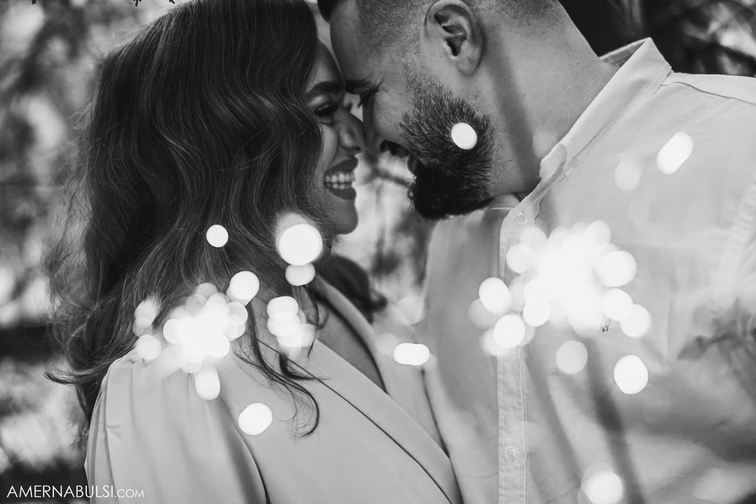 An intimate black and white portrait with bokeh light effects.