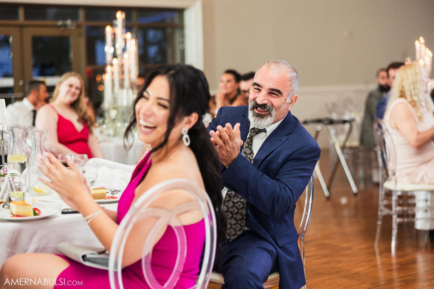 Wedding reception guests enjoying a fun moment at their decorated dining table.