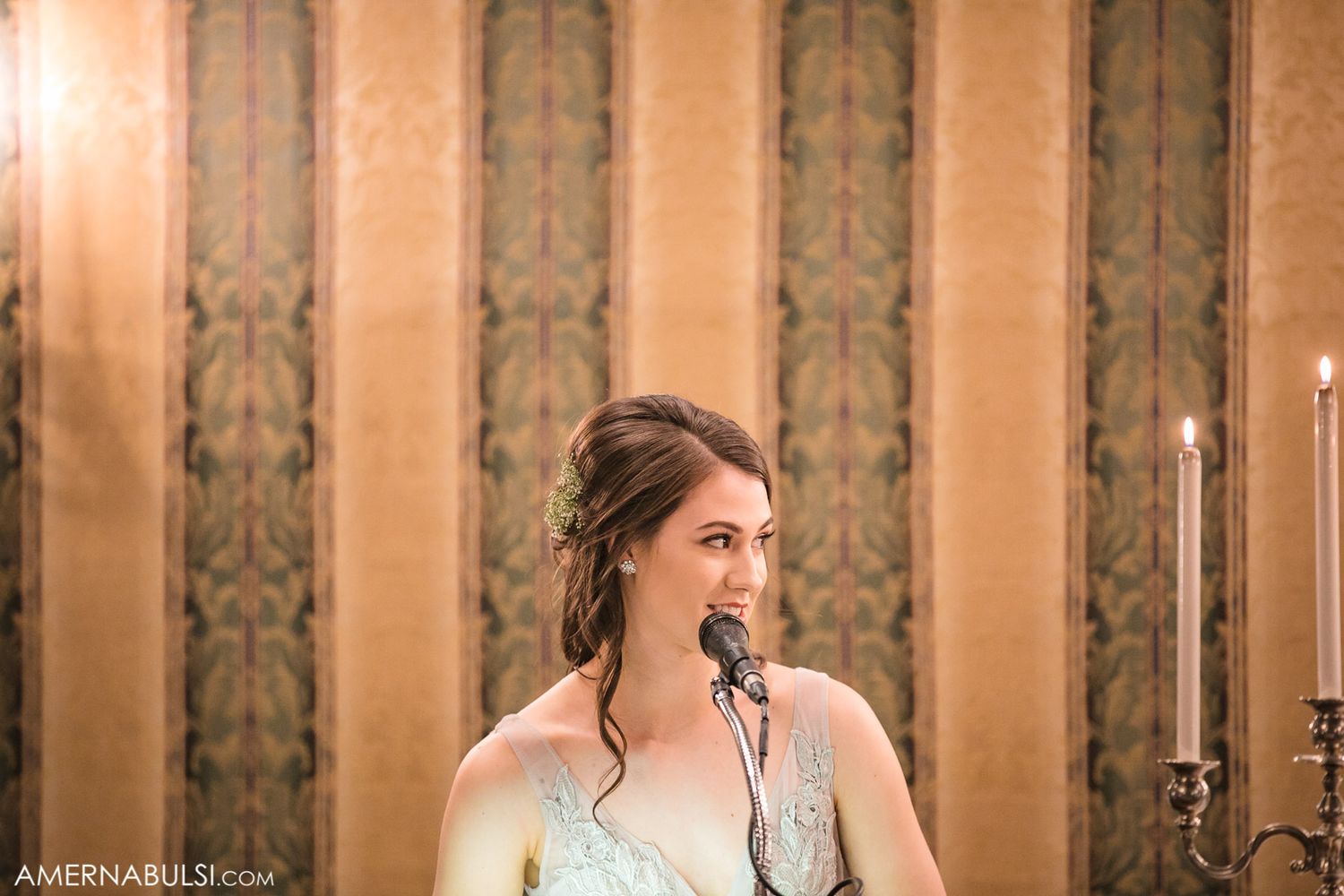 Elegant wedding reception venue with warm lighting and decorative wall panels.