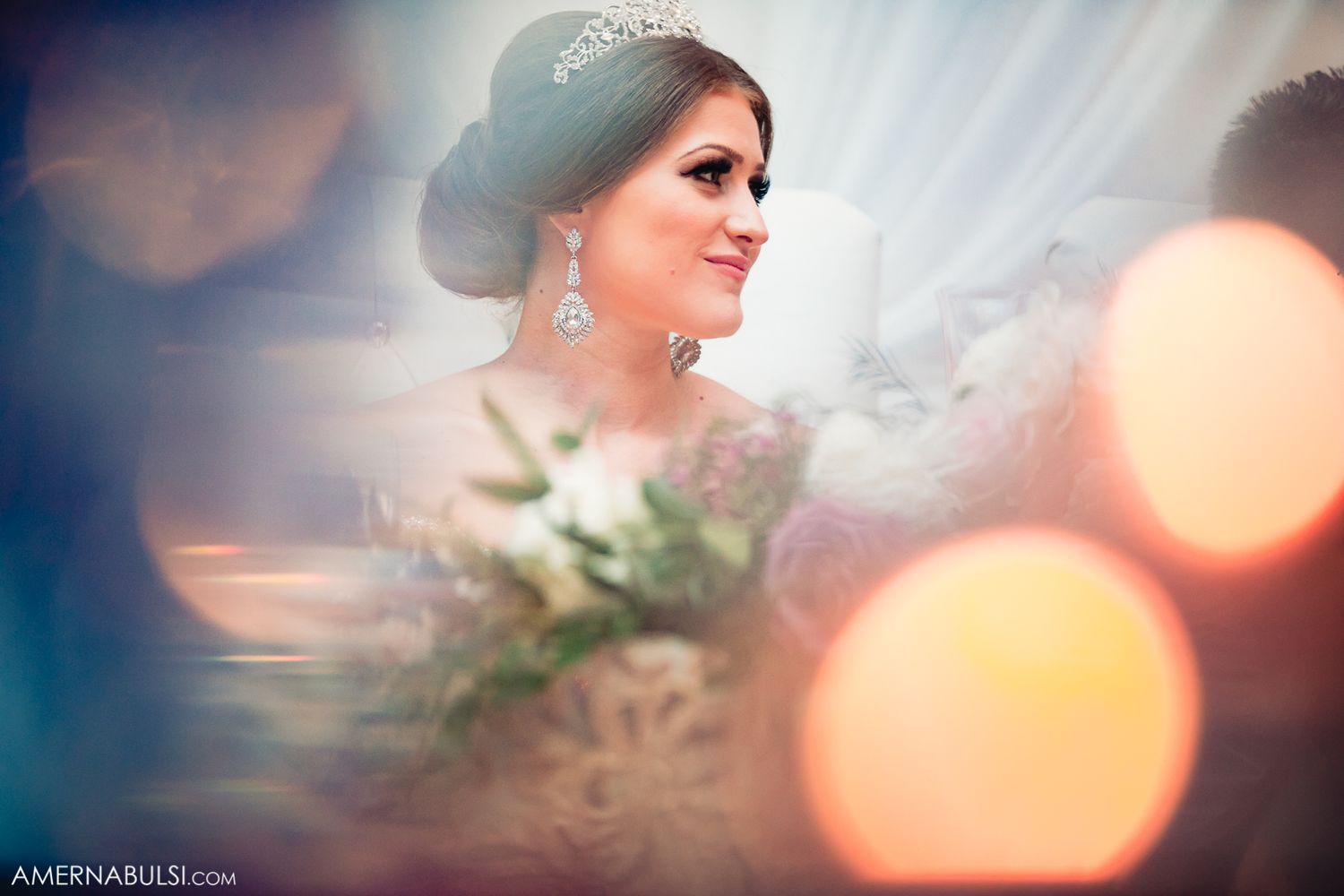 Soft focus wedding reception details with bokeh lighting effects creating a romantic atmosphere.