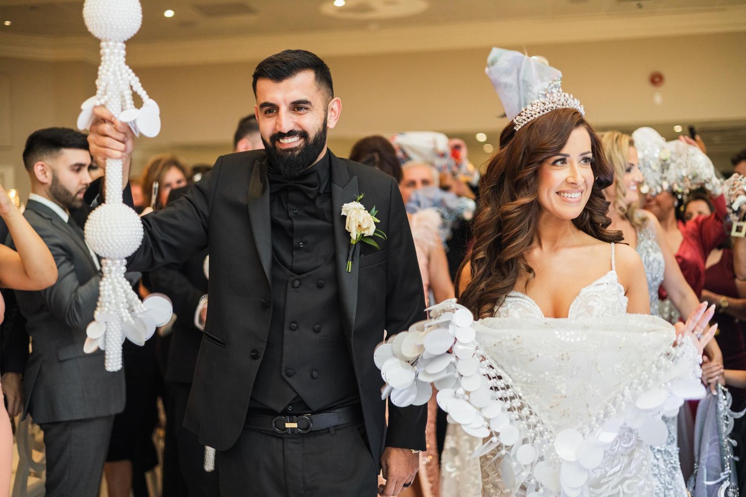 Wedding celebration with guests waving white napkins during reception festivities.