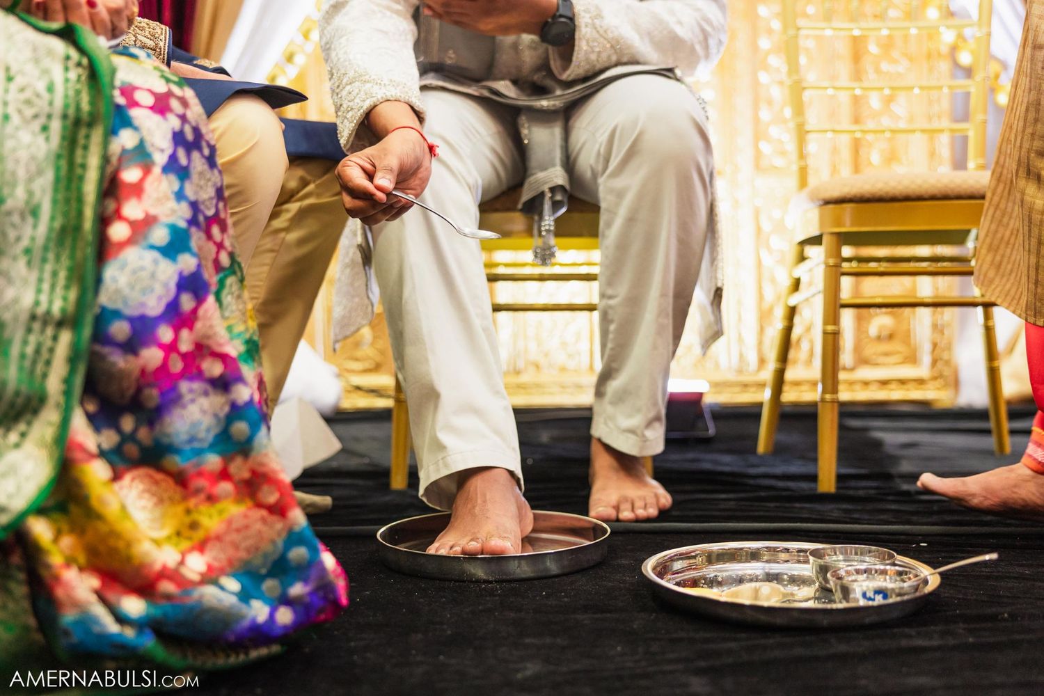 Detail shot of traditional Indian wedding ceremony rituals being performed on a black stage.