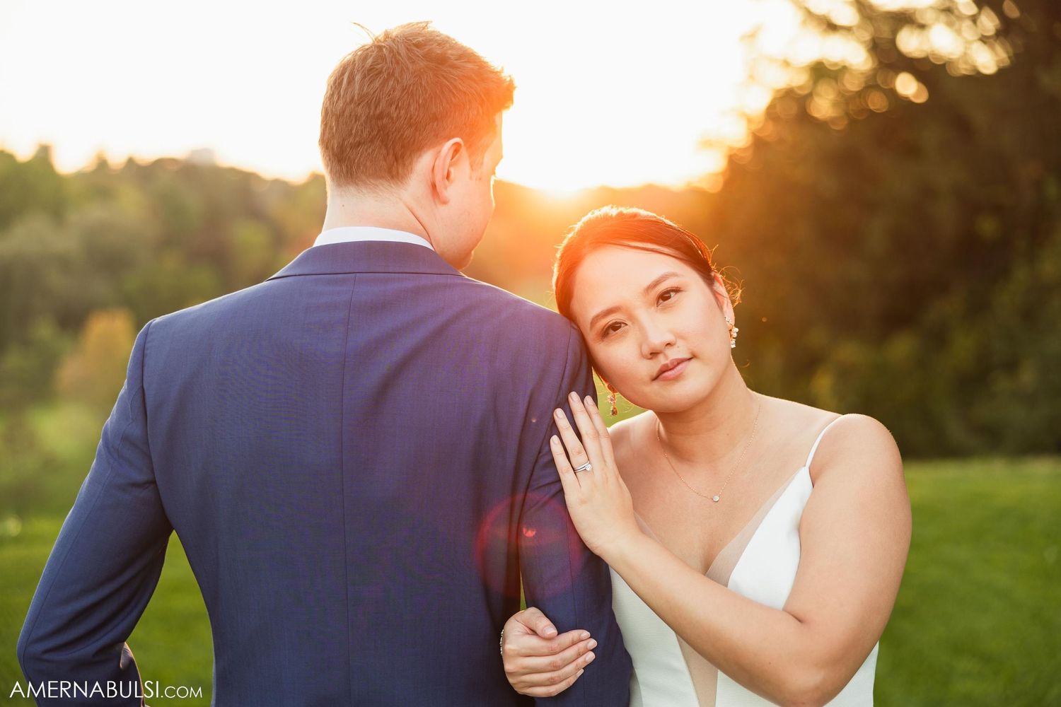 Romantic sunset portrait of a newlywed couple on their wedding day.