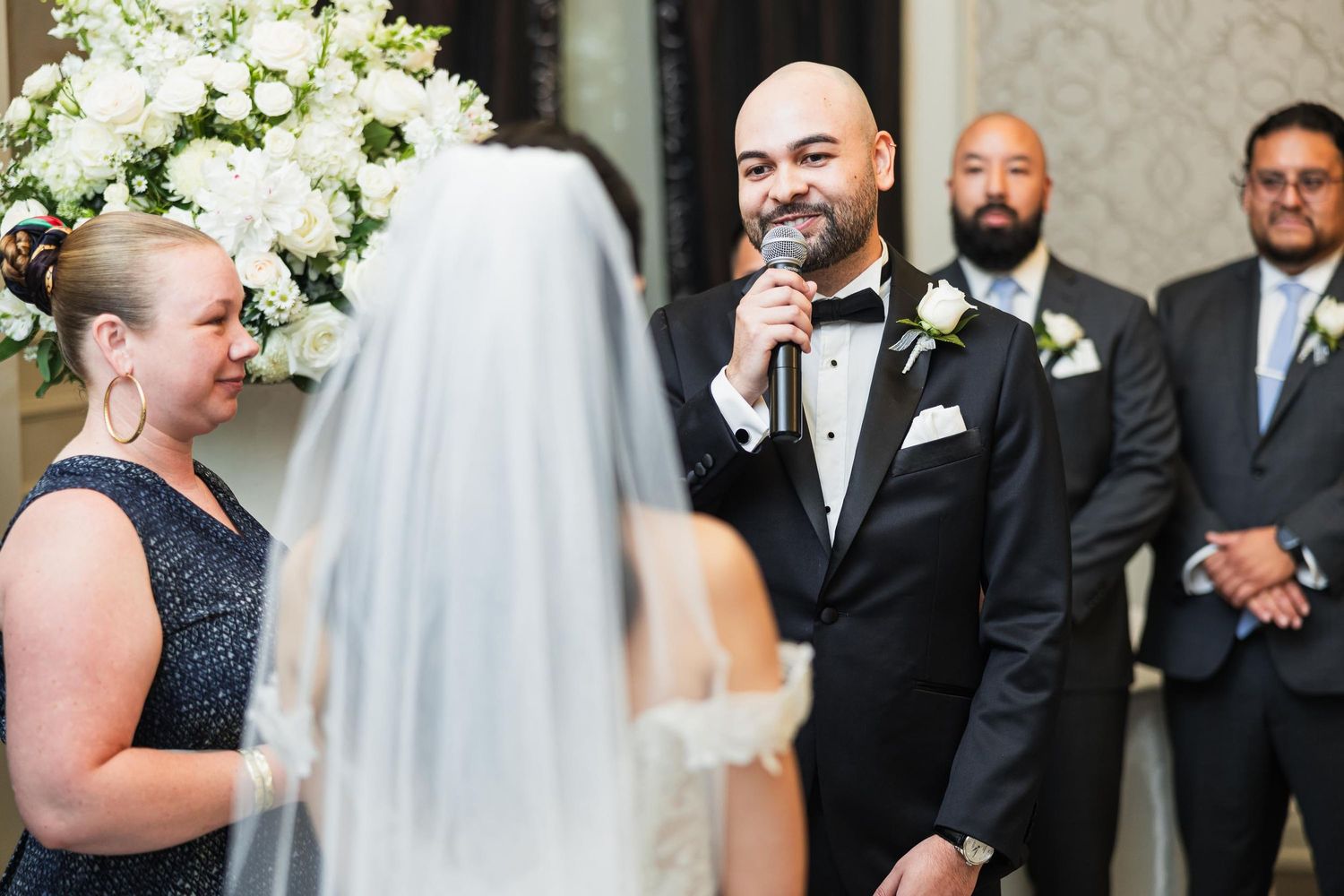 Wedding ceremony with emotional exchange of vows in elegant venue.