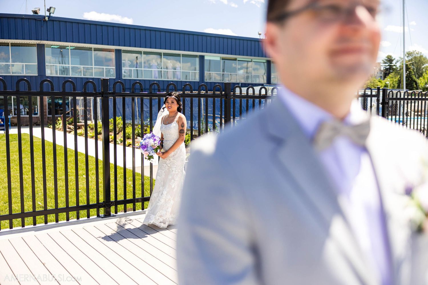 Creative wedding photo composition with couple separated by foreground elements.