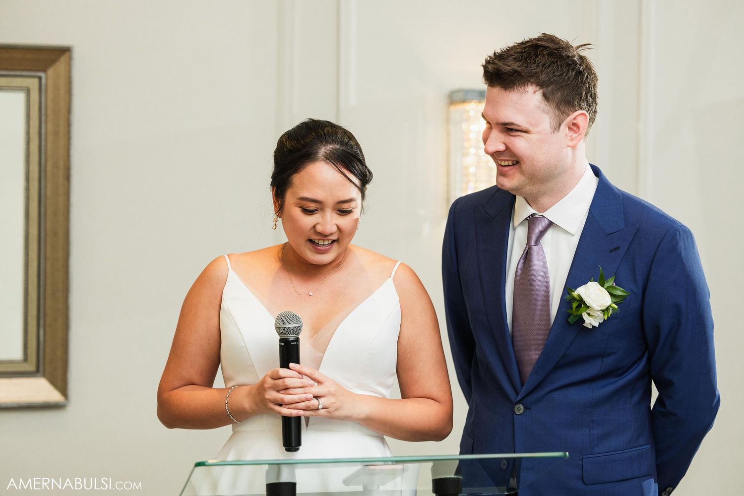 Wedding couple delivers heartfelt speech together during reception celebration.
