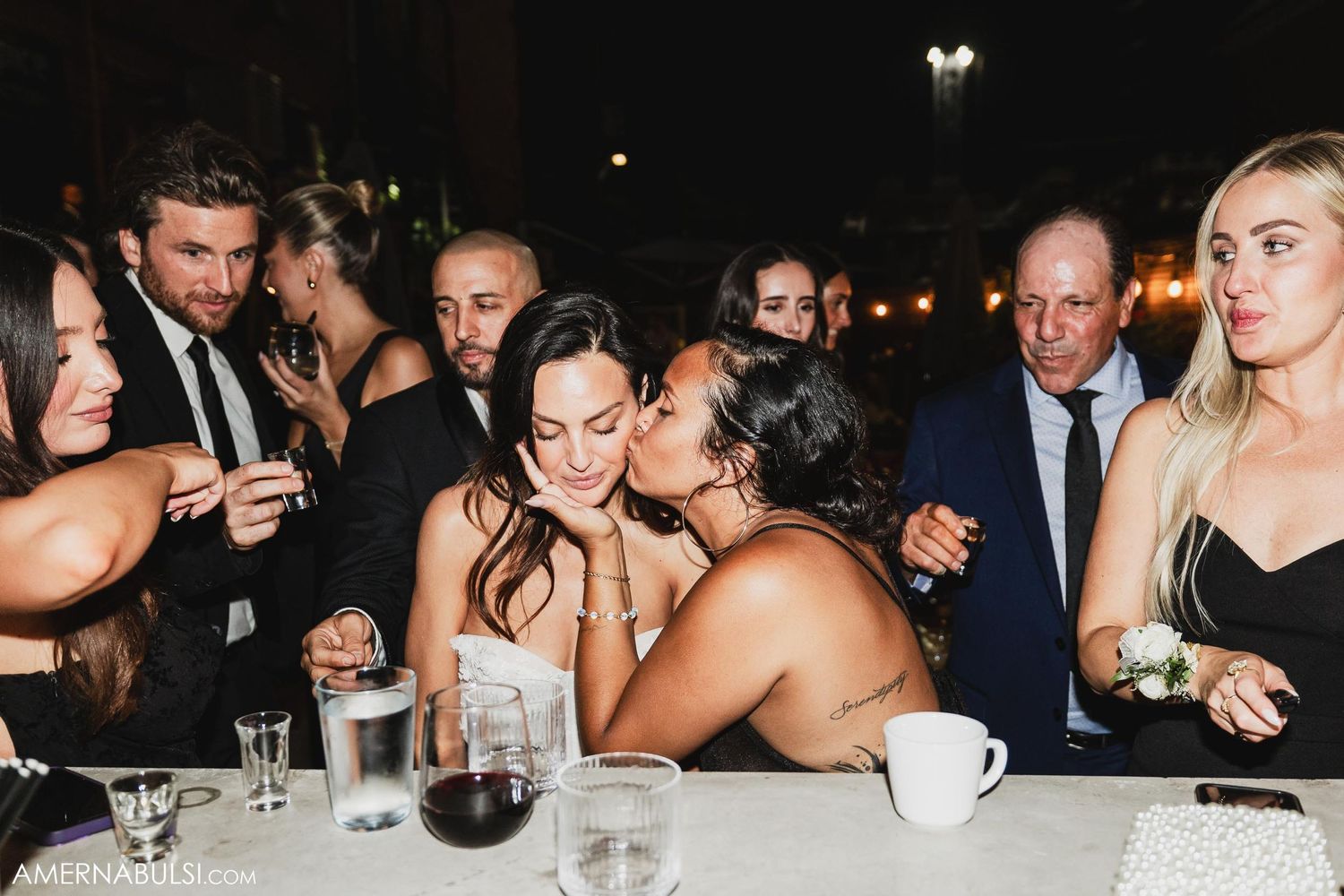 Candid moment of celebration at dining table with wine glasses.