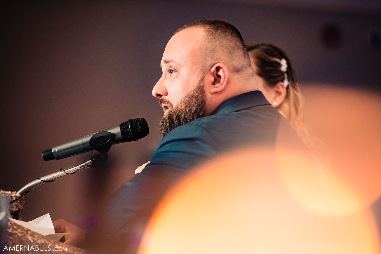 Close-up shots of a wedding ceremony speaker and guests in warm lighting.