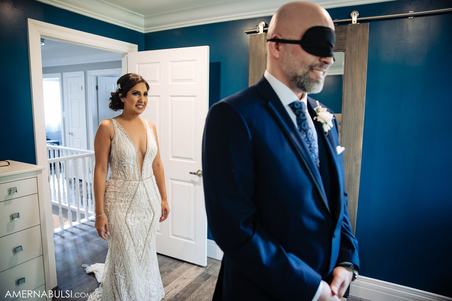 Interior hallway scene with navy blue walls and white trim during wedding preparations.
