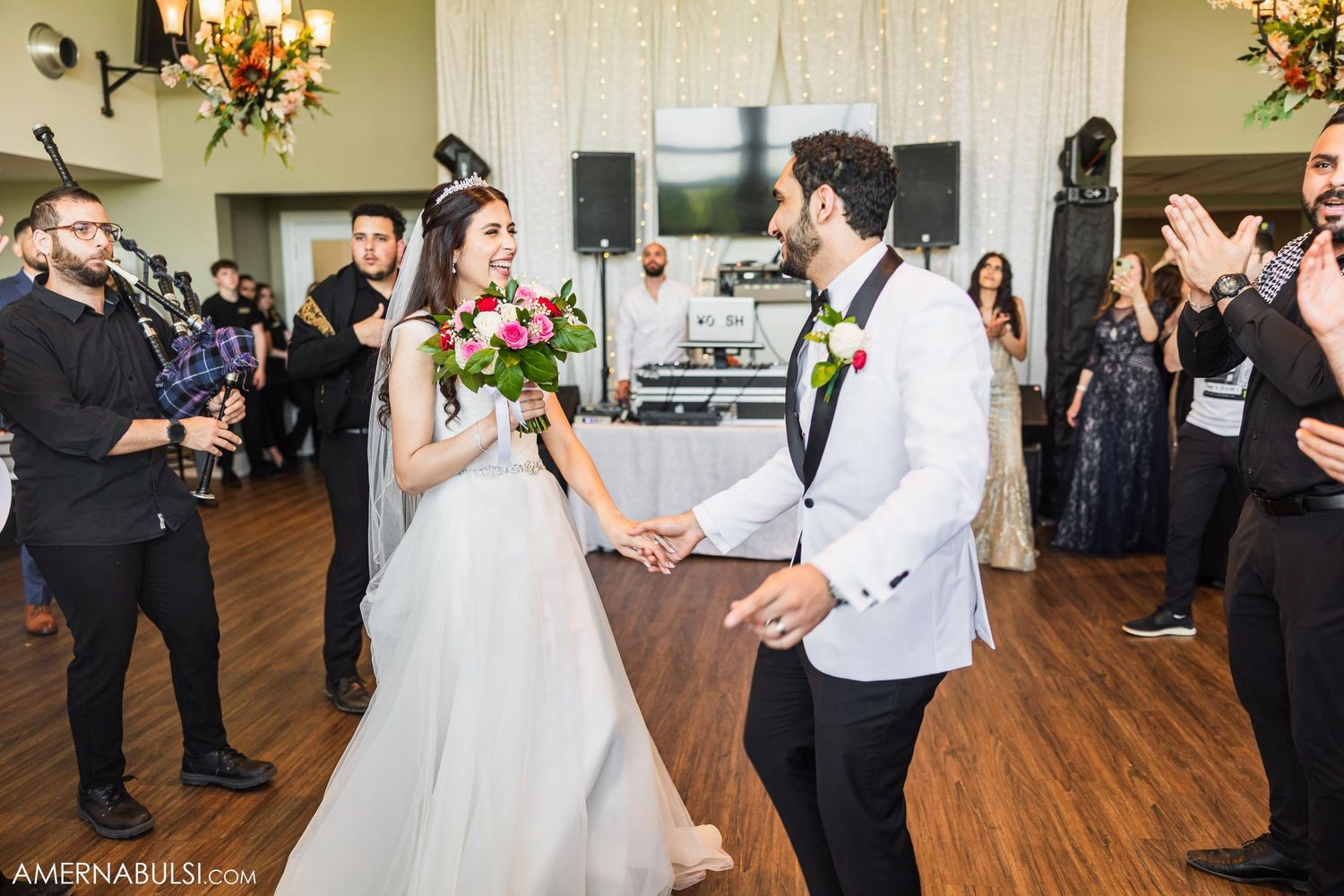 A couple shares a romantic moment during their wedding dance in front of guests.