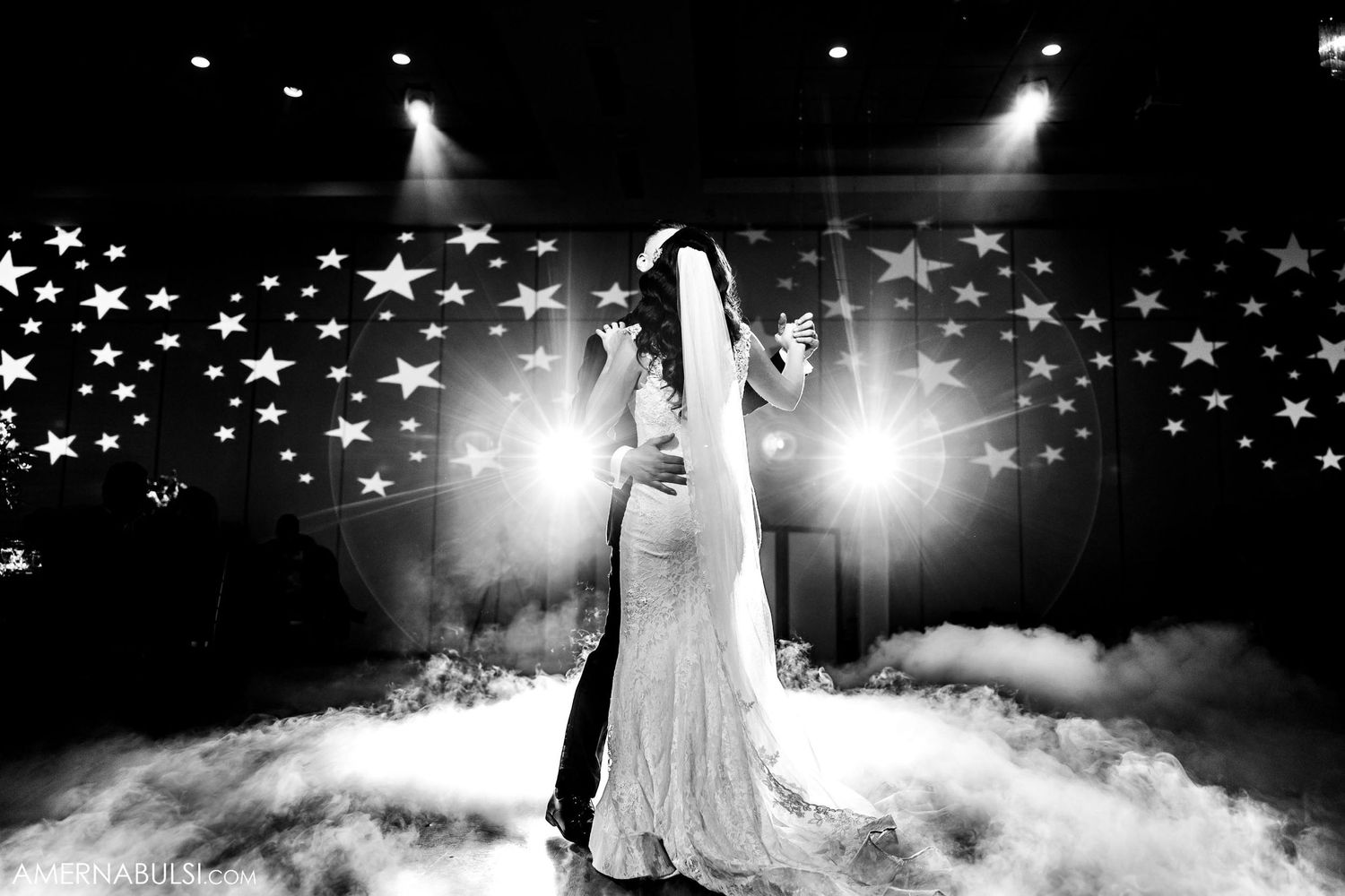 Artistic black and white wedding photo with star lights and fog effects creating magical atmosphere.