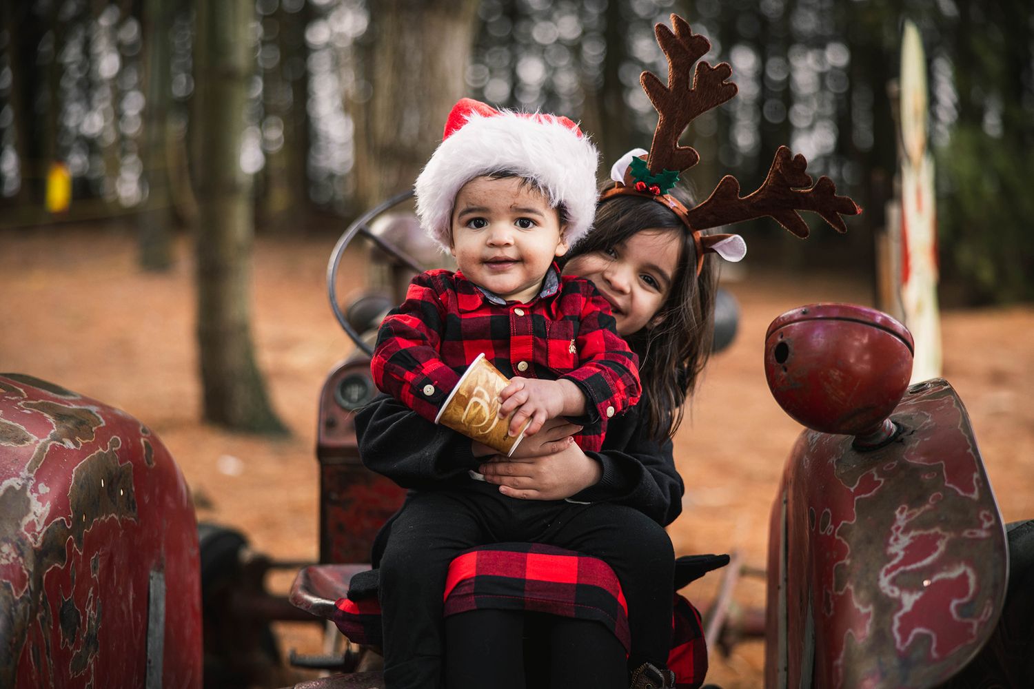 Child in buffalo plaid winter clothing playing in a rustic outdoor setting.
