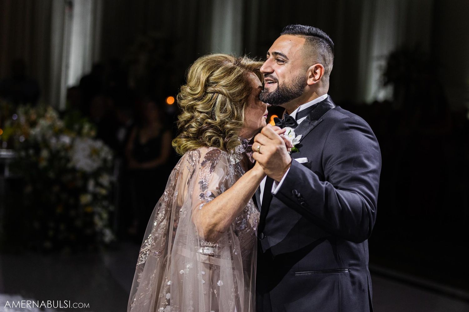 Intimate dance moment captured at elegant indoor wedding reception.