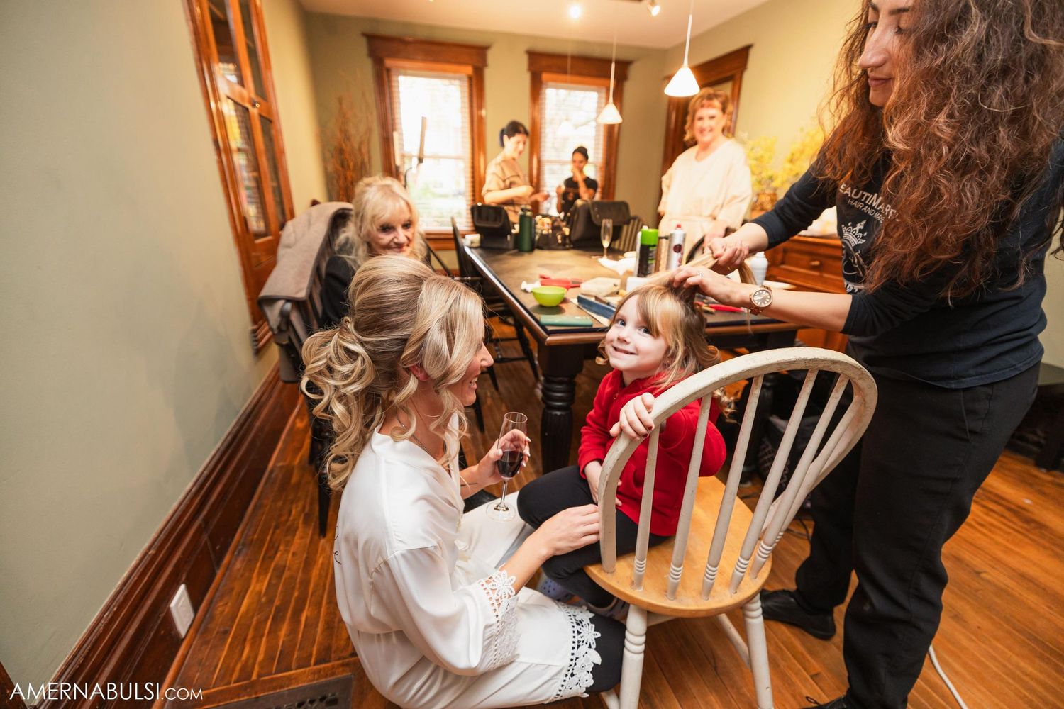 People gathered around a table during wedding preparation activities.