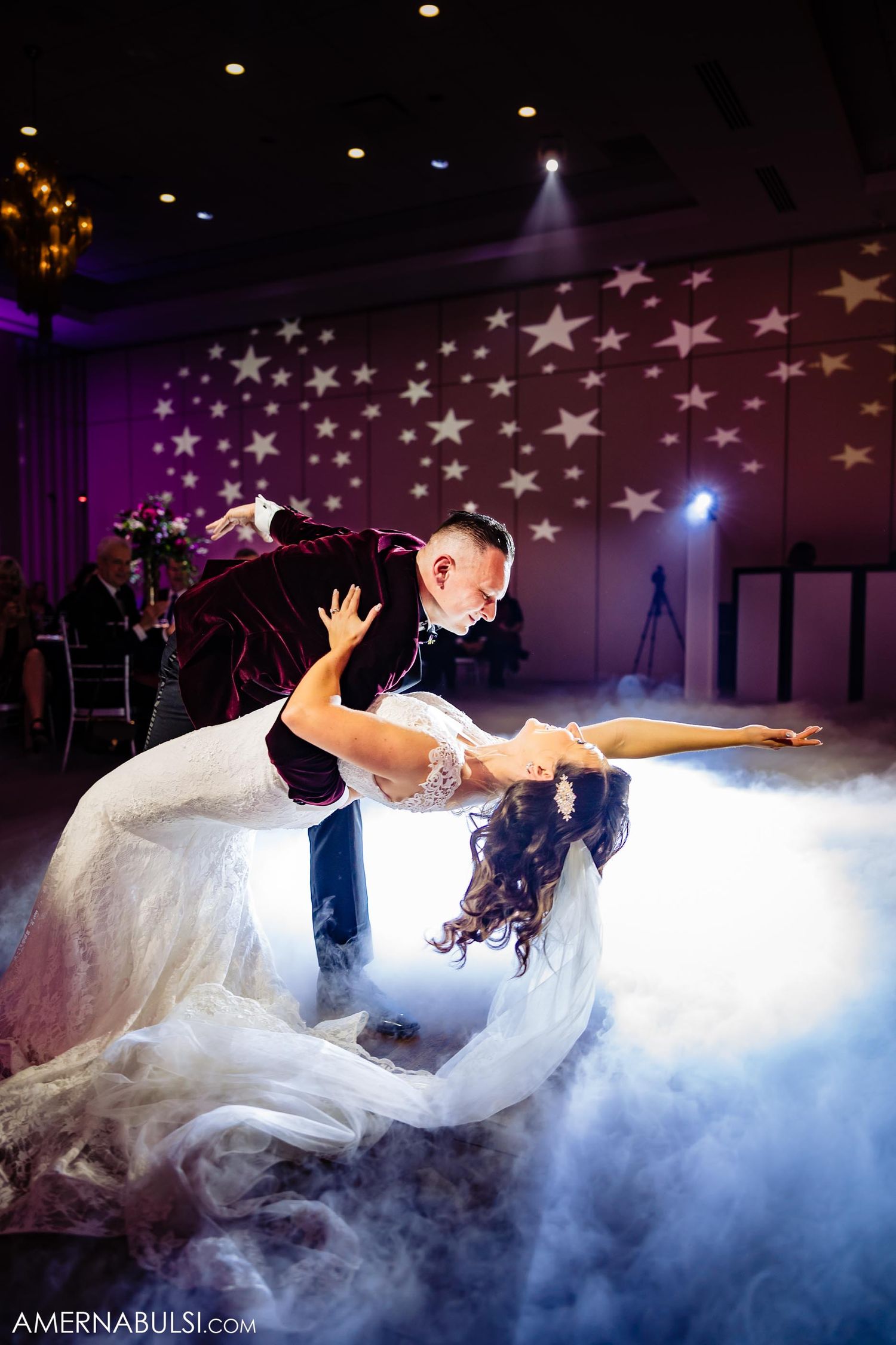 Dramatic dip during first dance with star projections and fog effects on the dance floor.