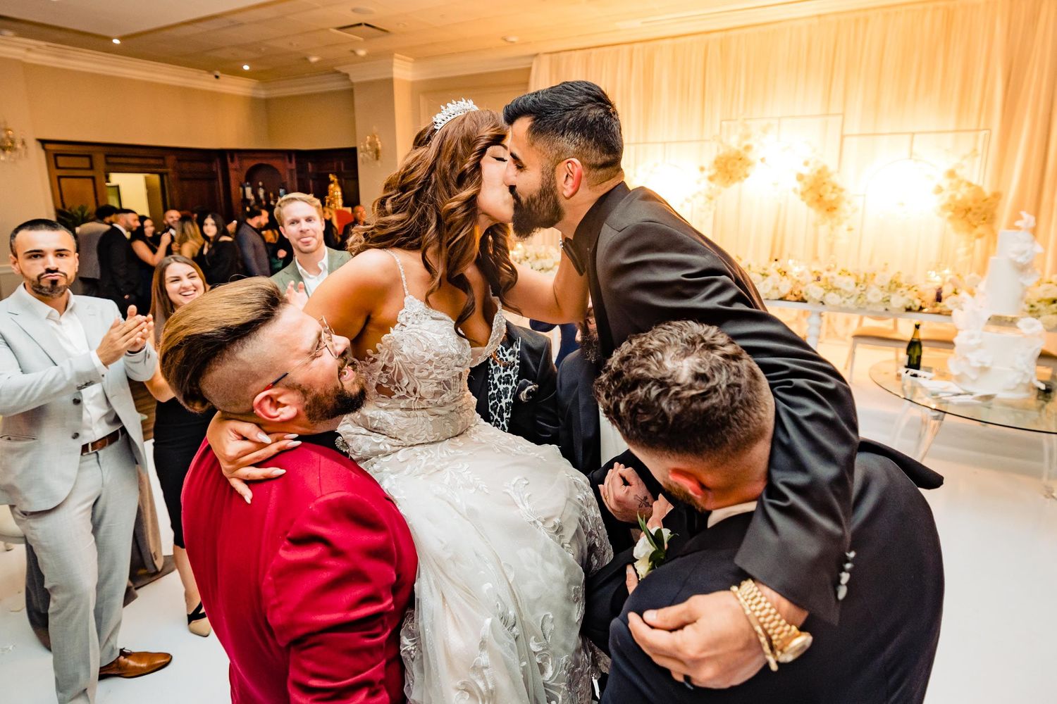 Wedding celebration moment captured during reception with guests cheering.