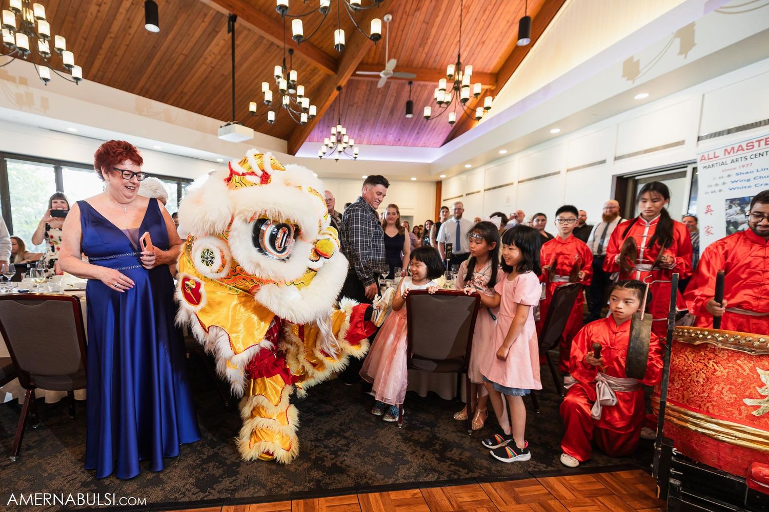 Traditional Chinese lion dance performer entertains guests at a wedding reception.