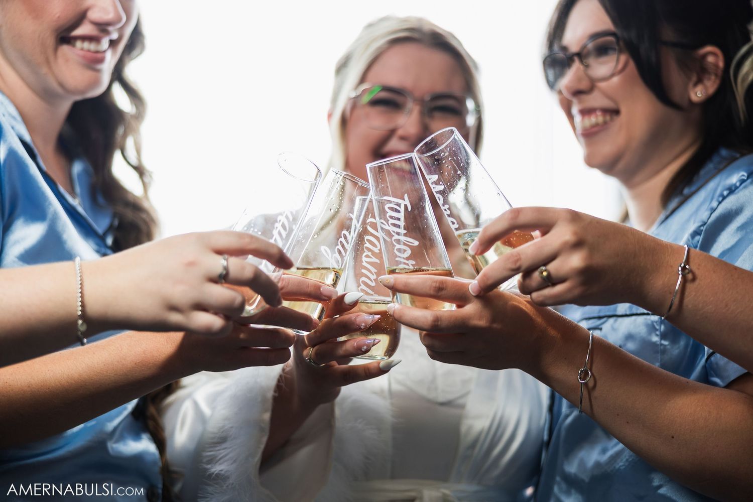 Friends toasting and clinking glasses together in a celebratory moment.