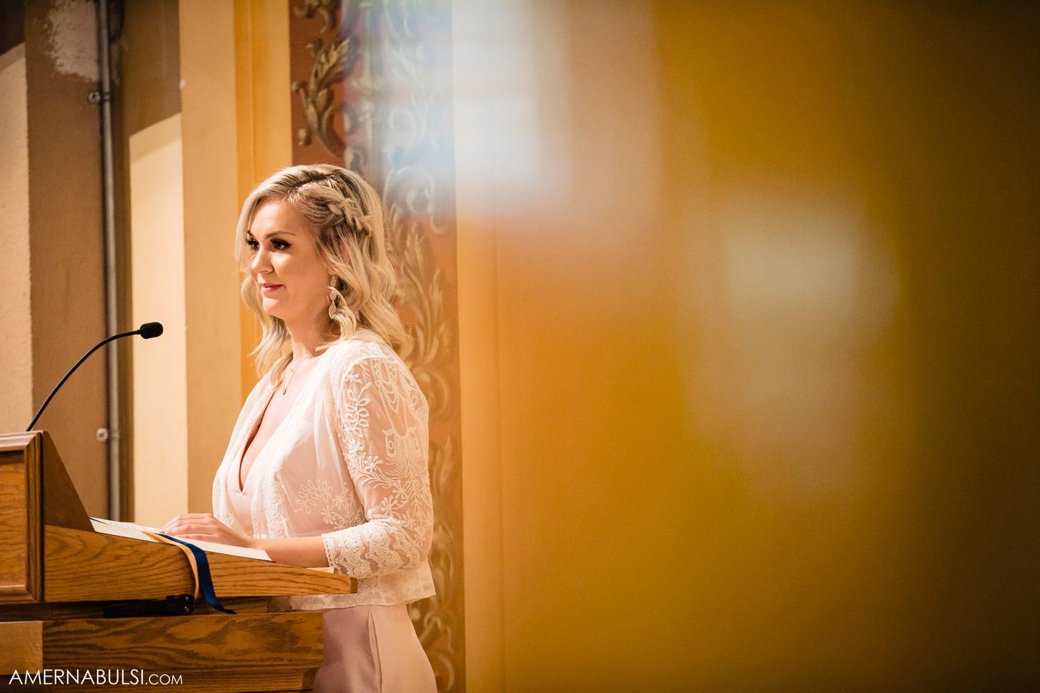 Warm toned candid moments captured during wedding preparation in golden lighting.