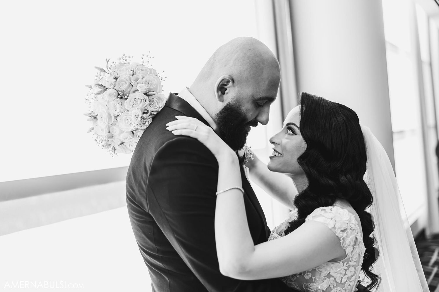Black and white intimate portrait of newlyweds sharing a romantic moment.
