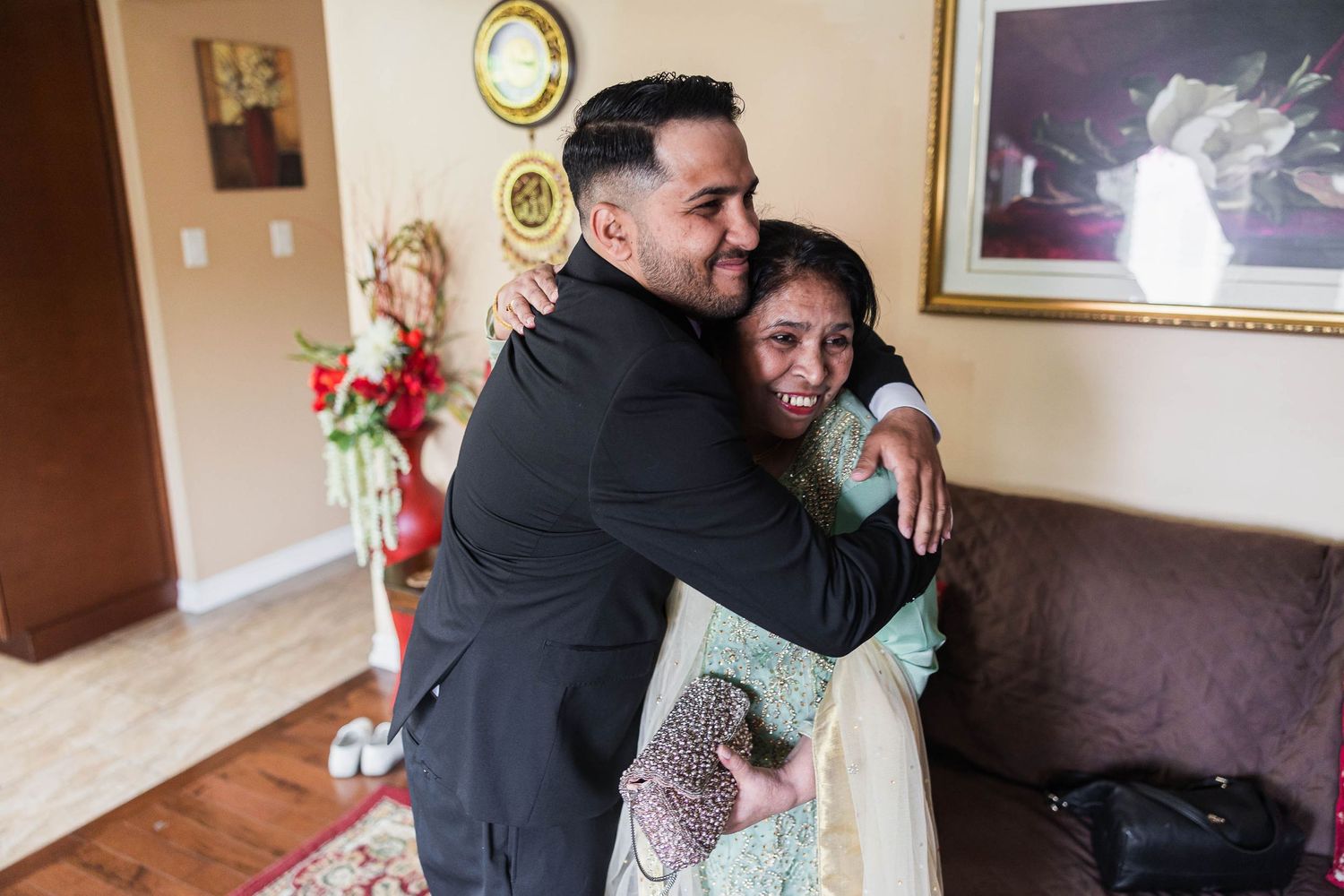 Wedding celebration moment with warm indoor embrace.