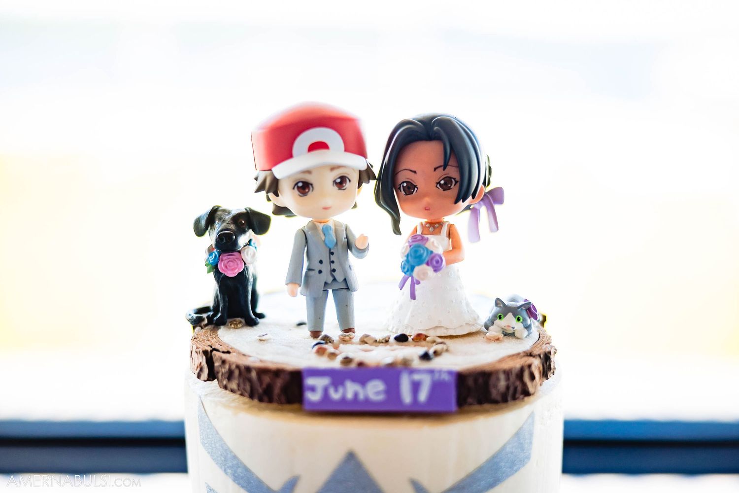 Cute anime-style wedding cake topper featuring characters with a small black dog.