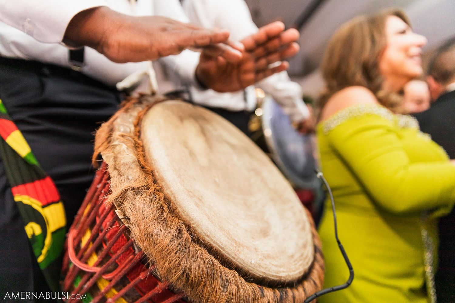 Close-up of a decorative drum being played during wedding festivities.
