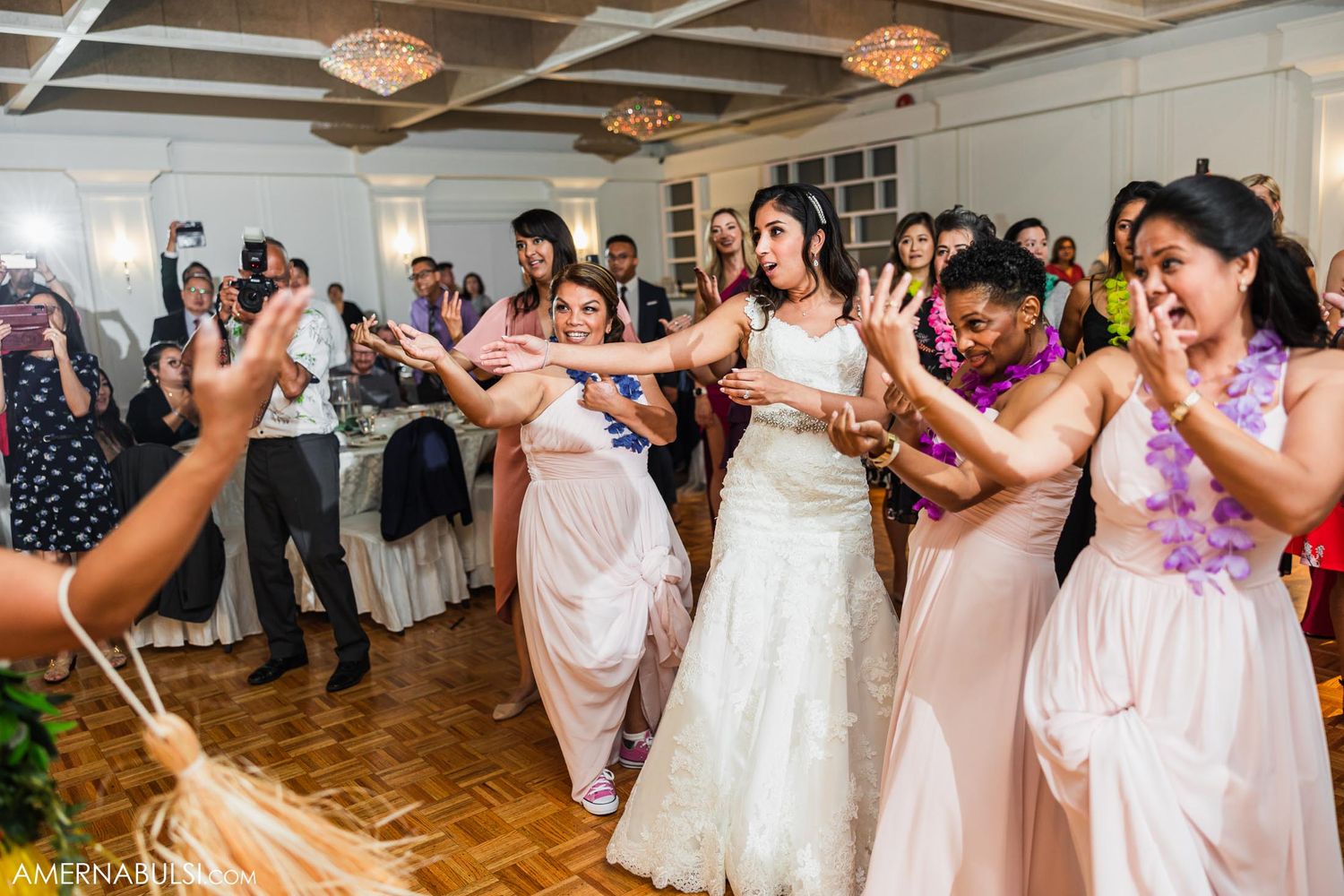 Wedding party dancing and celebrating on the dance floor during a reception.
