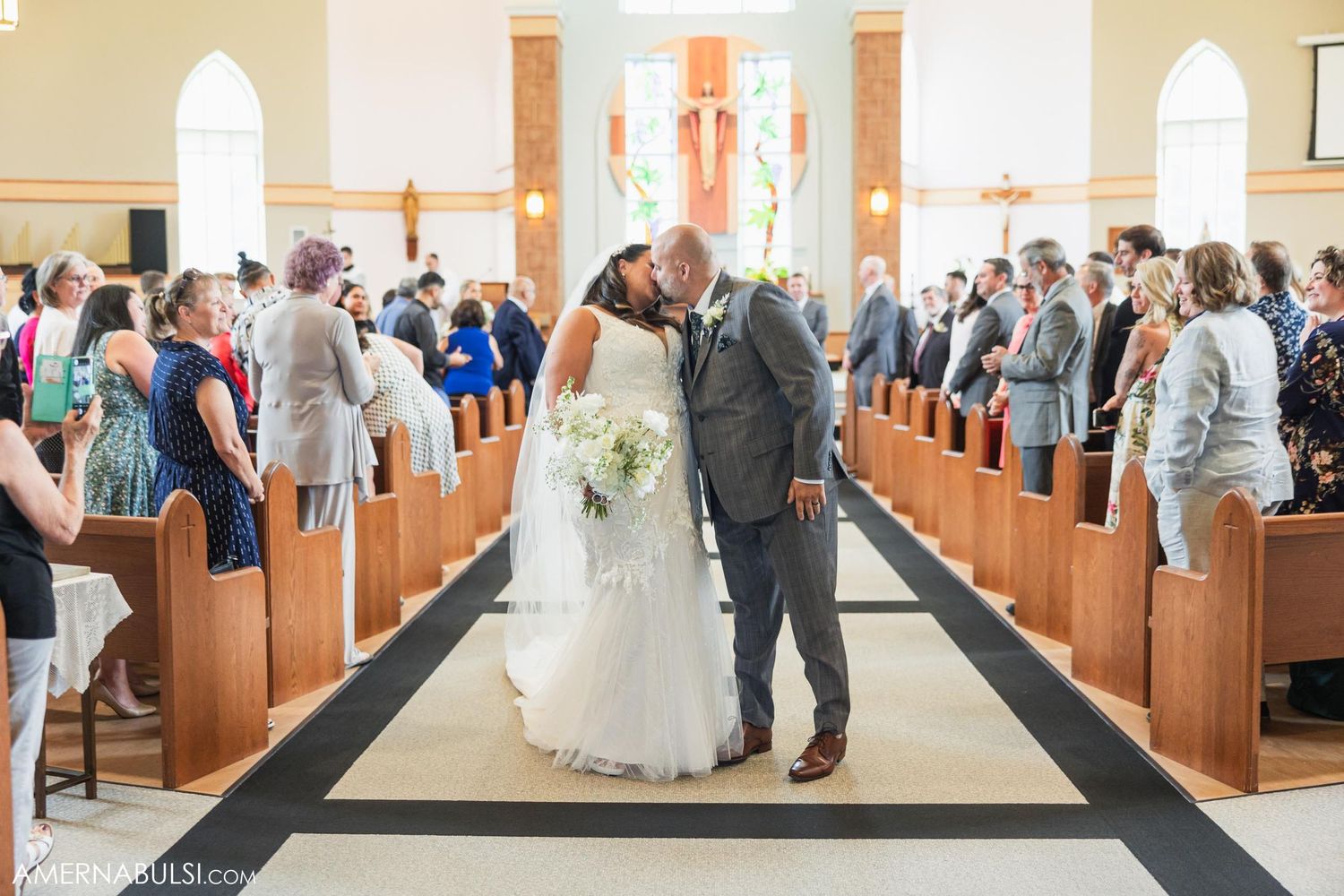 Traditional church wedding ceremony in a sunlit sanctuary with wooden pews.