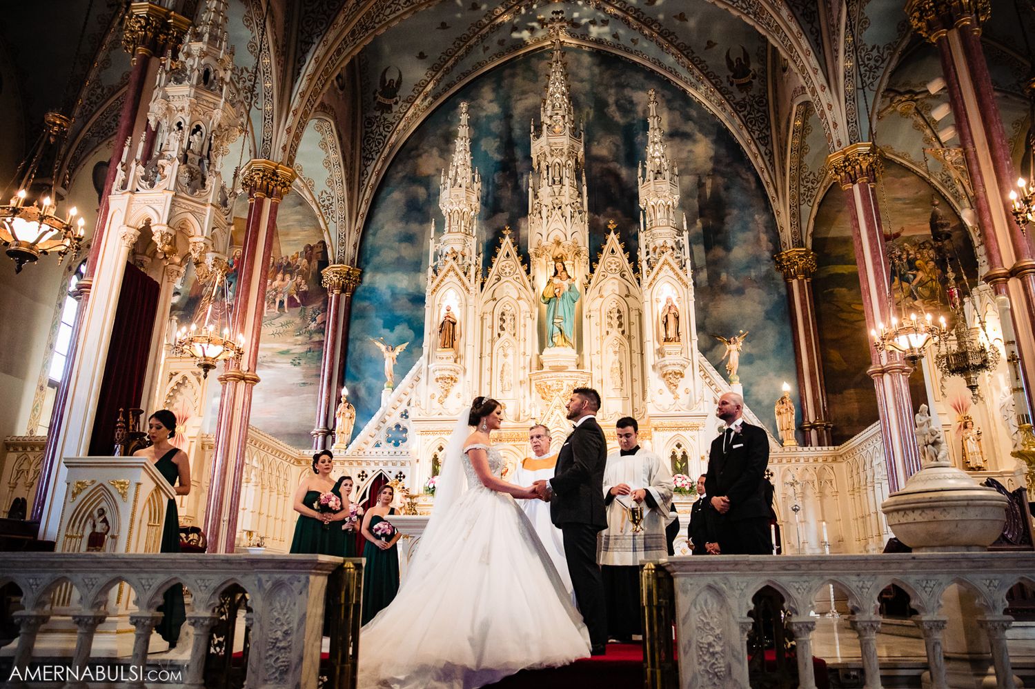 Cathedral wedding ceremony with ornate gothic architecture and dramatic lighting.