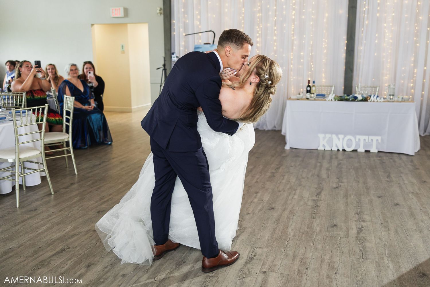 Wedding reception dance party with guests enjoying themselves on a modern wood floor venue.