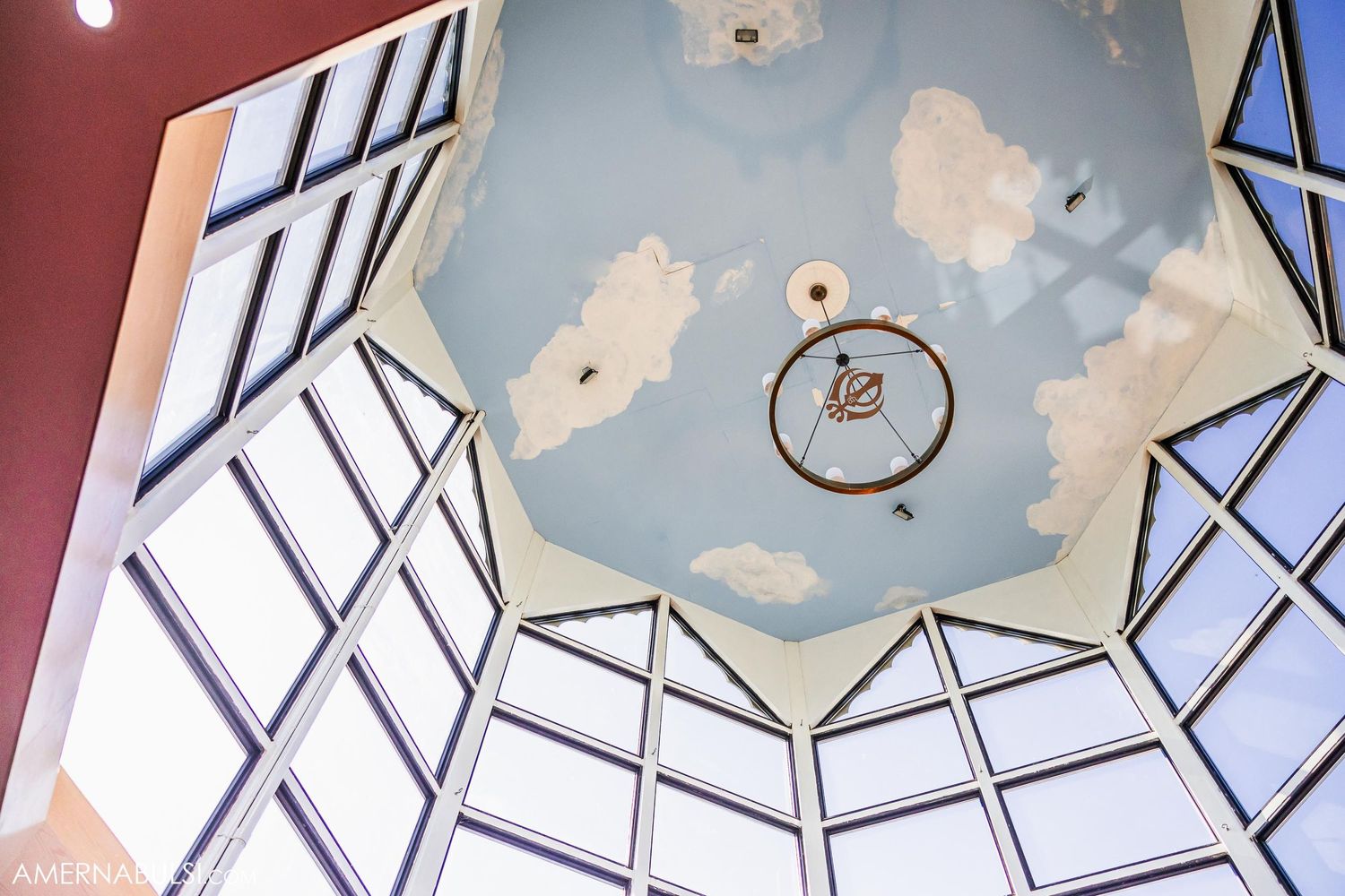 Architectural detail of a modern skylight with decorative ceiling design and hanging light fixture.