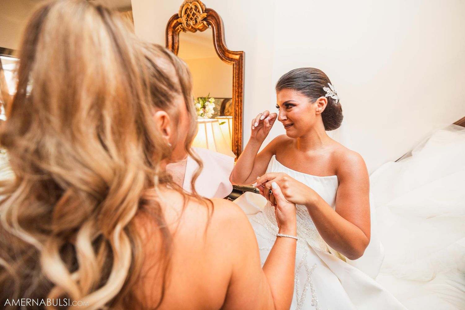 Emotional moment during bridal preparation with elegant mirror reflection.