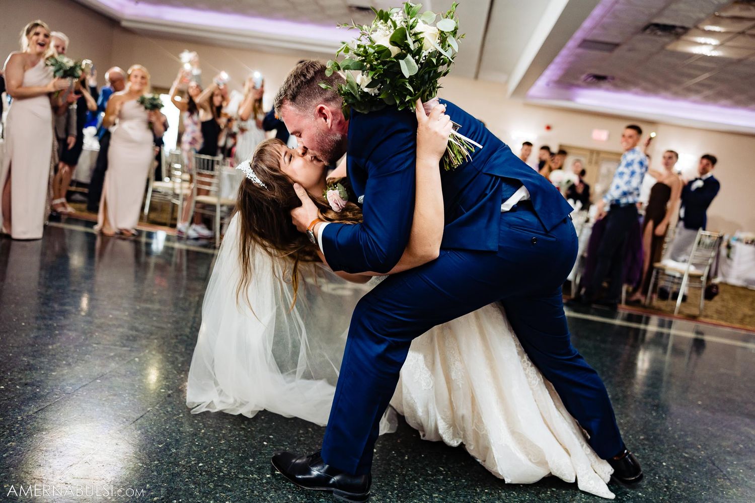 Dramatic dip pose during first dance at wedding reception.