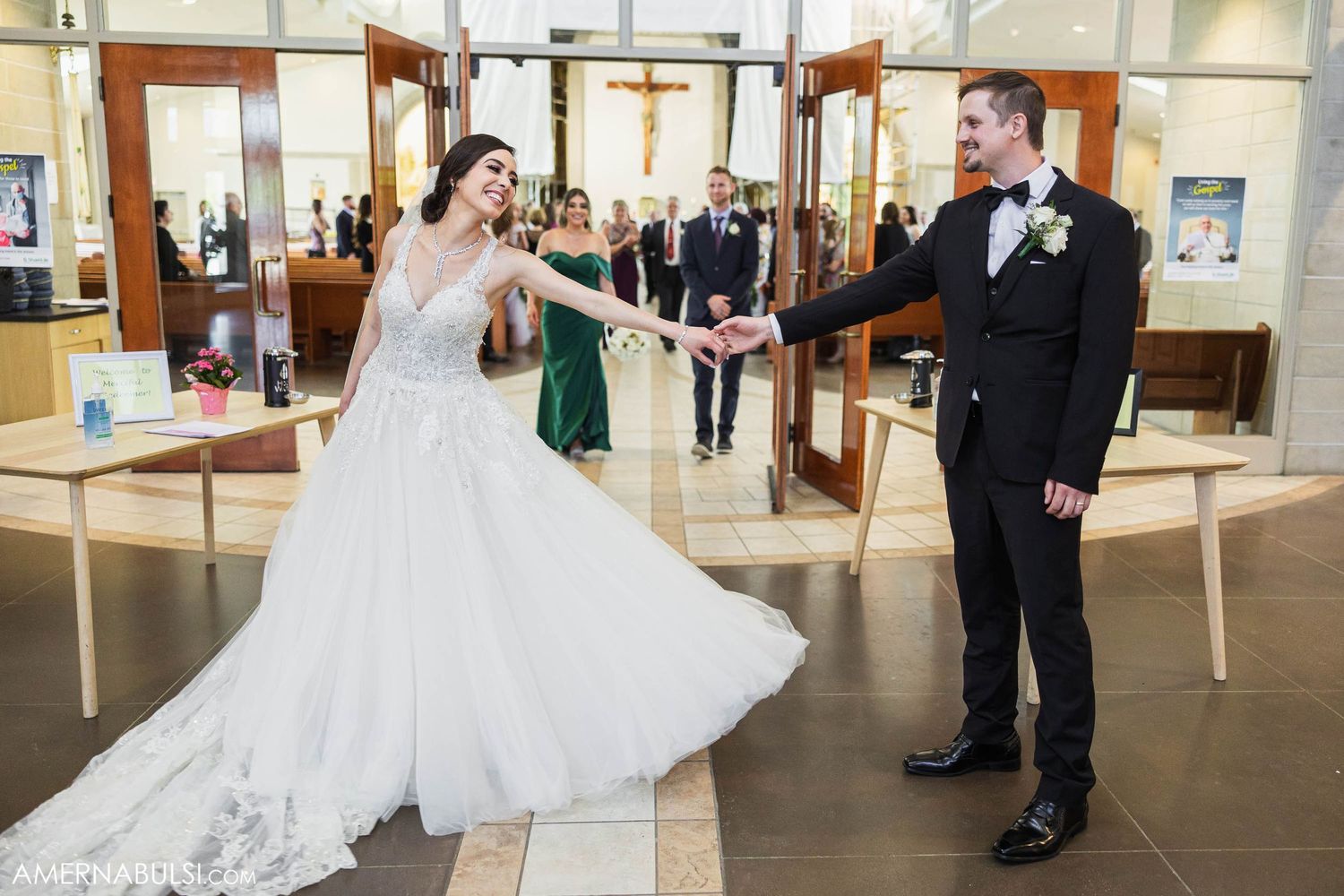A playful moment between newlyweds dancing in a modern reception venue.