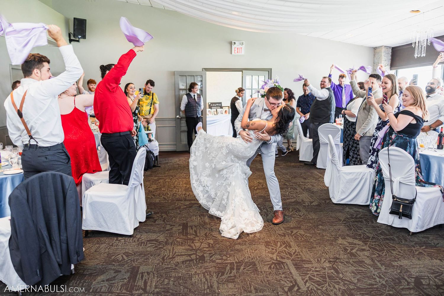 Wedding guests celebrate on the dance floor as a couple shares their first dance.
