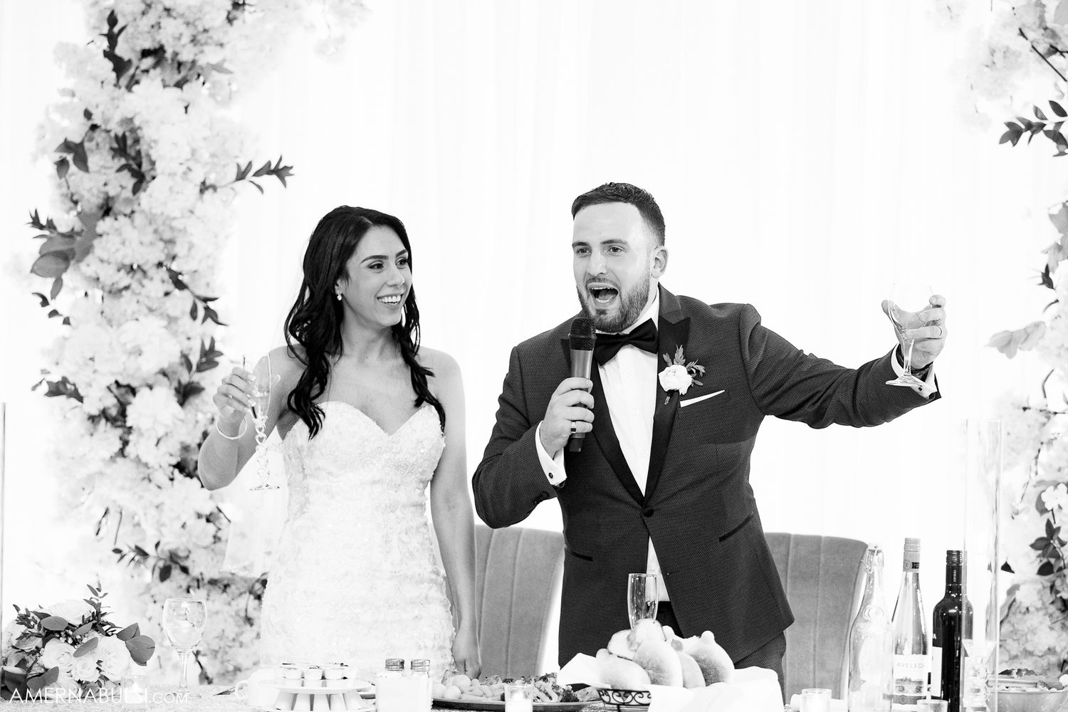 Wedding party members laugh and celebrate together in a series of candid black and white reception photos.