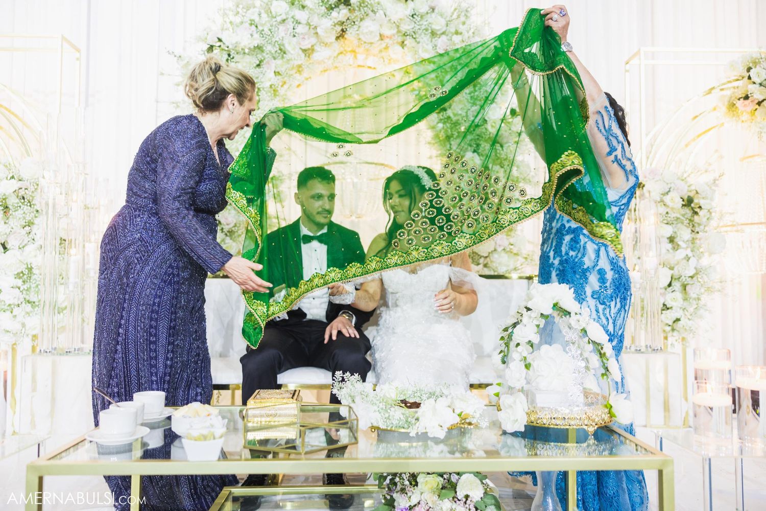 Traditional wedding ceremony with green and blue fabric canopy.