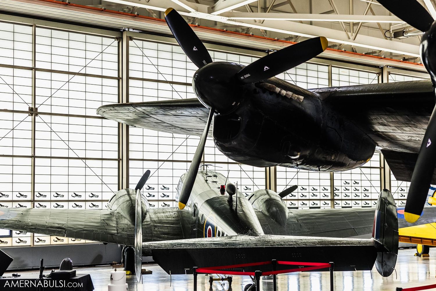 Close-up view of vintage aircraft propeller and engine in museum display.