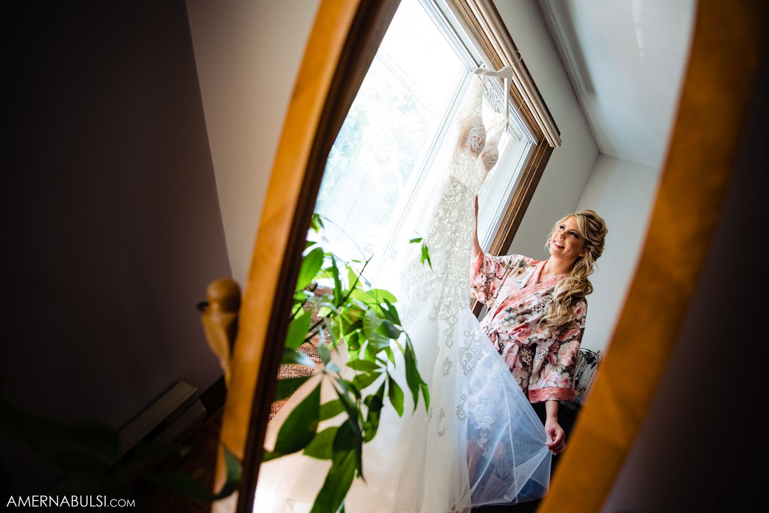Candid getting ready moments captured through a window frame.