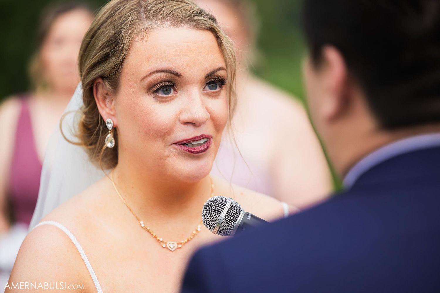 Emotional wedding ceremony moment captured during outdoor vow exchange.