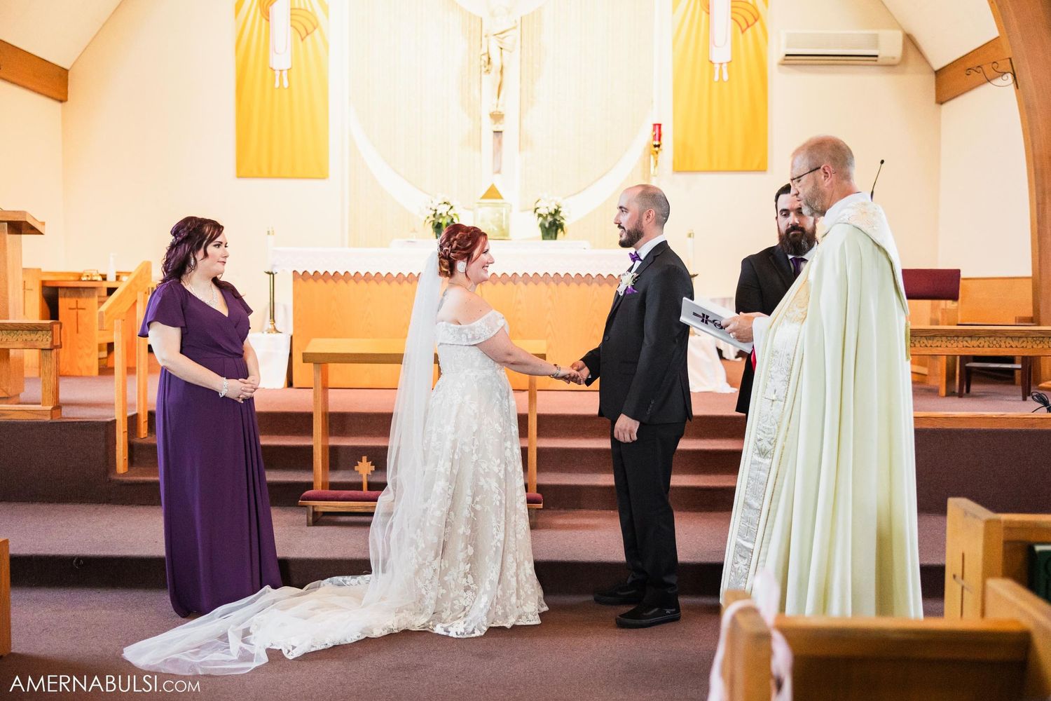 Traditional church wedding ceremony with priest officiating and purple-clad attendant.