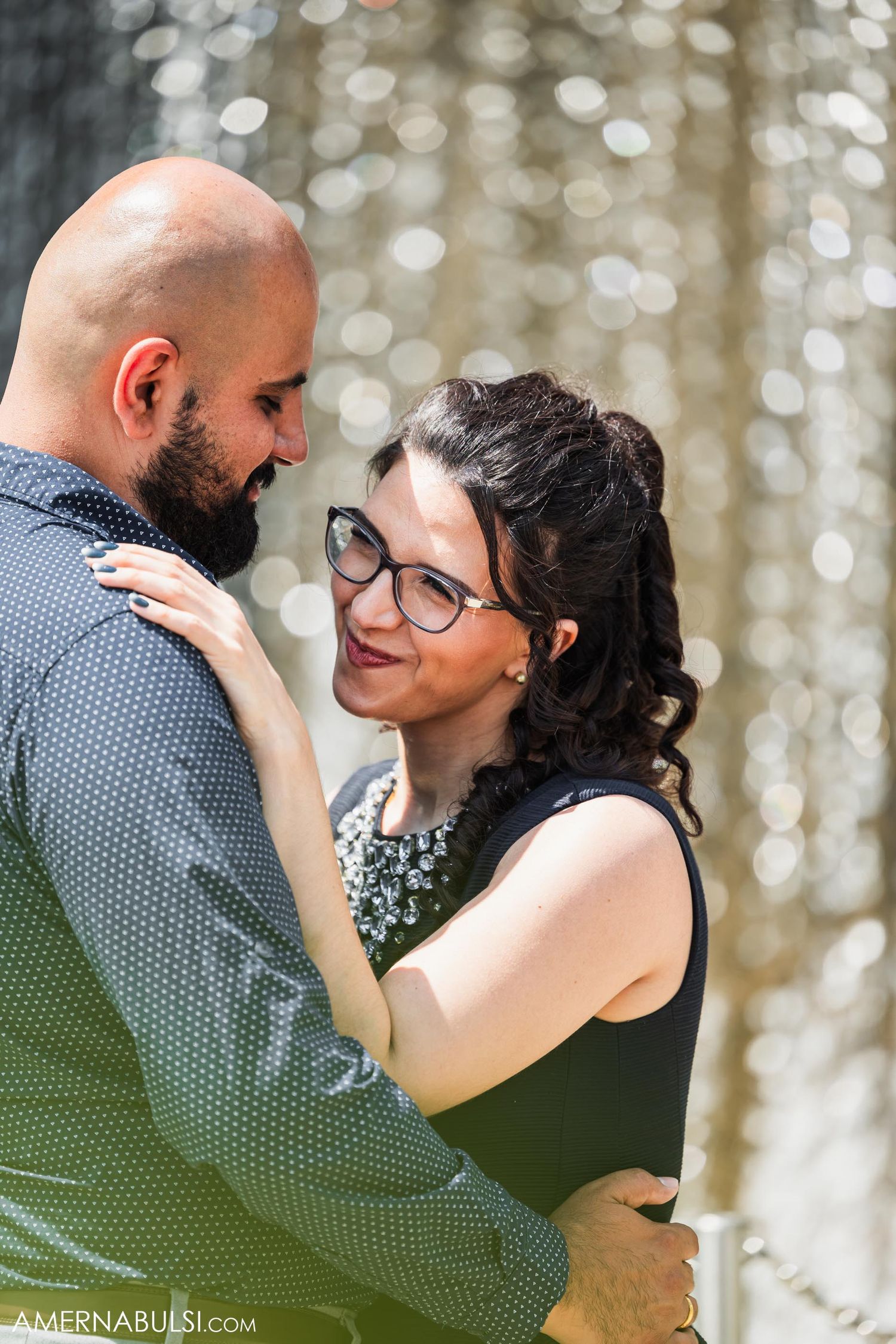 An intimate moment captured between a couple against a bokeh background.